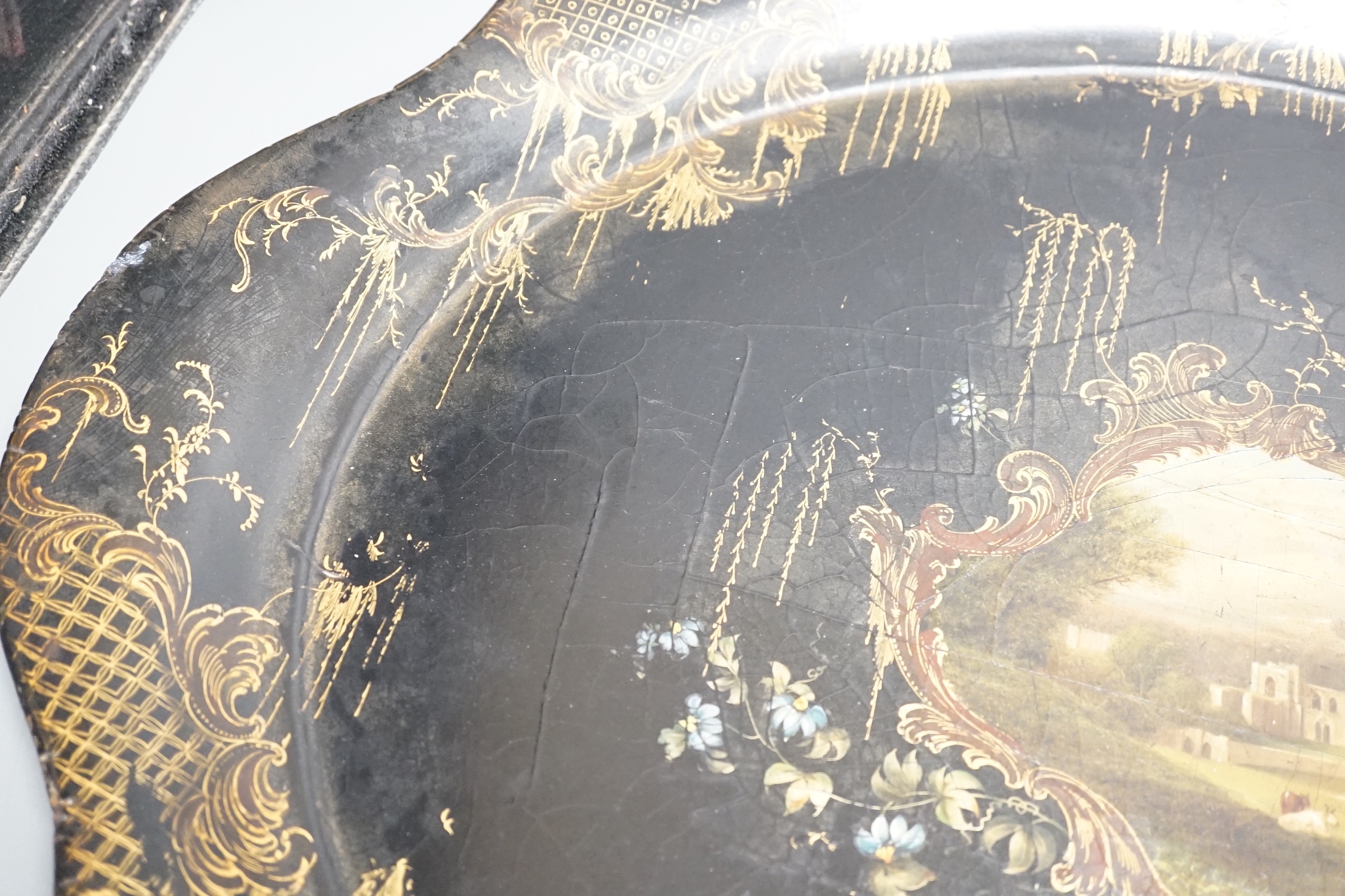 A Victorian papier mache tray, painted with ruins in a landscape - 64cm wide